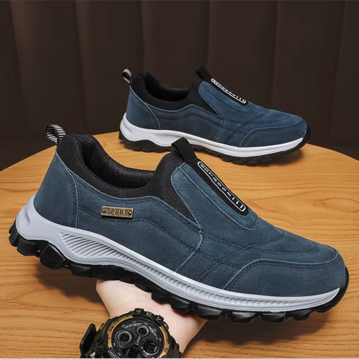 Pair of navy blue slip-on sneakers with white and black soles