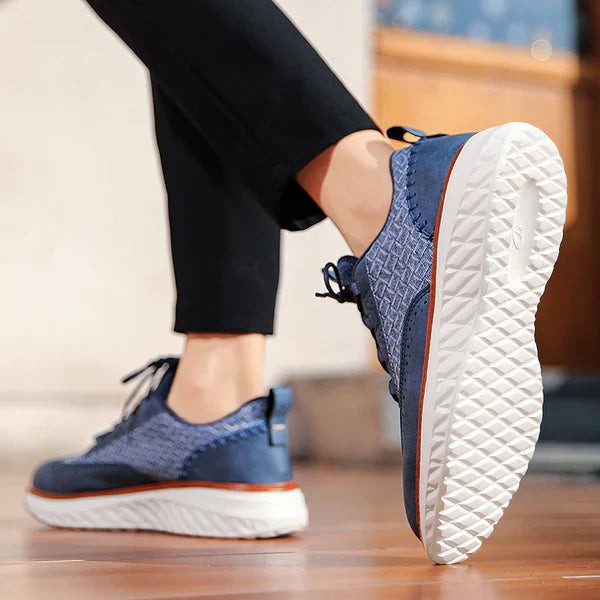 Blue leather sneaker in motion showing textured tread and lace-up design
