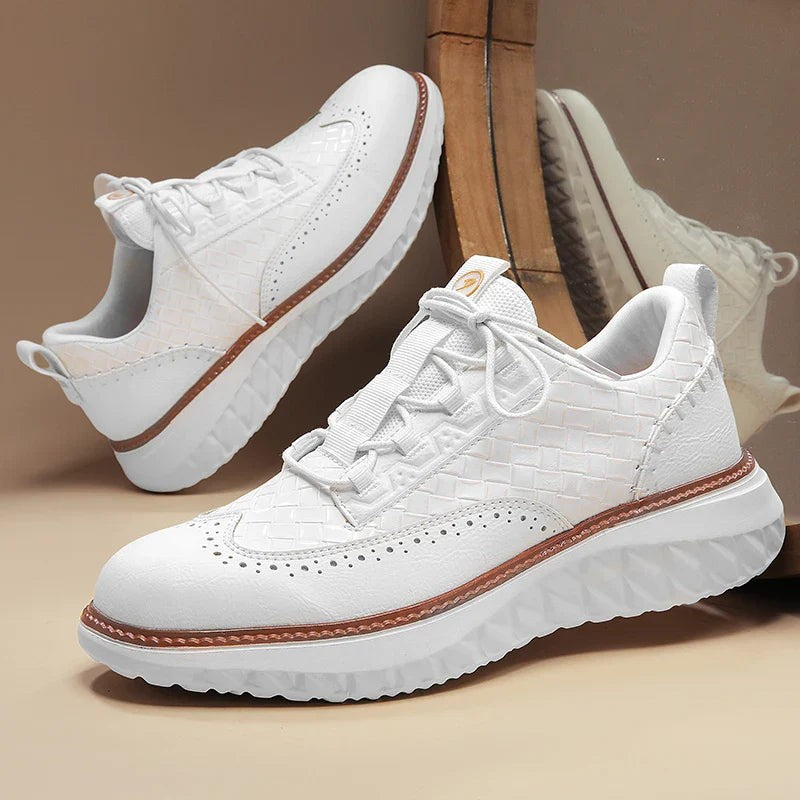 Pair of white woven leather sneakers with brogue accents and thick sole