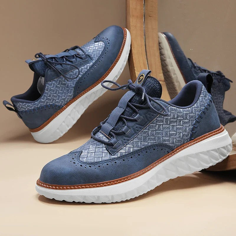 Pair of blue woven leather sneakers with brogue detailing and white sole