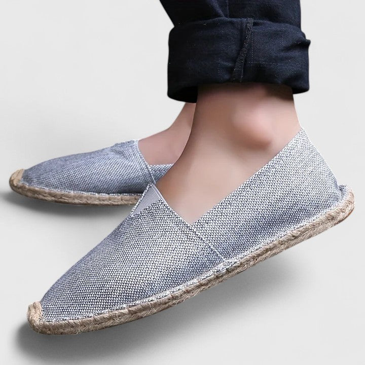 gray textured slip-on espadrilles worn with cropped black pants