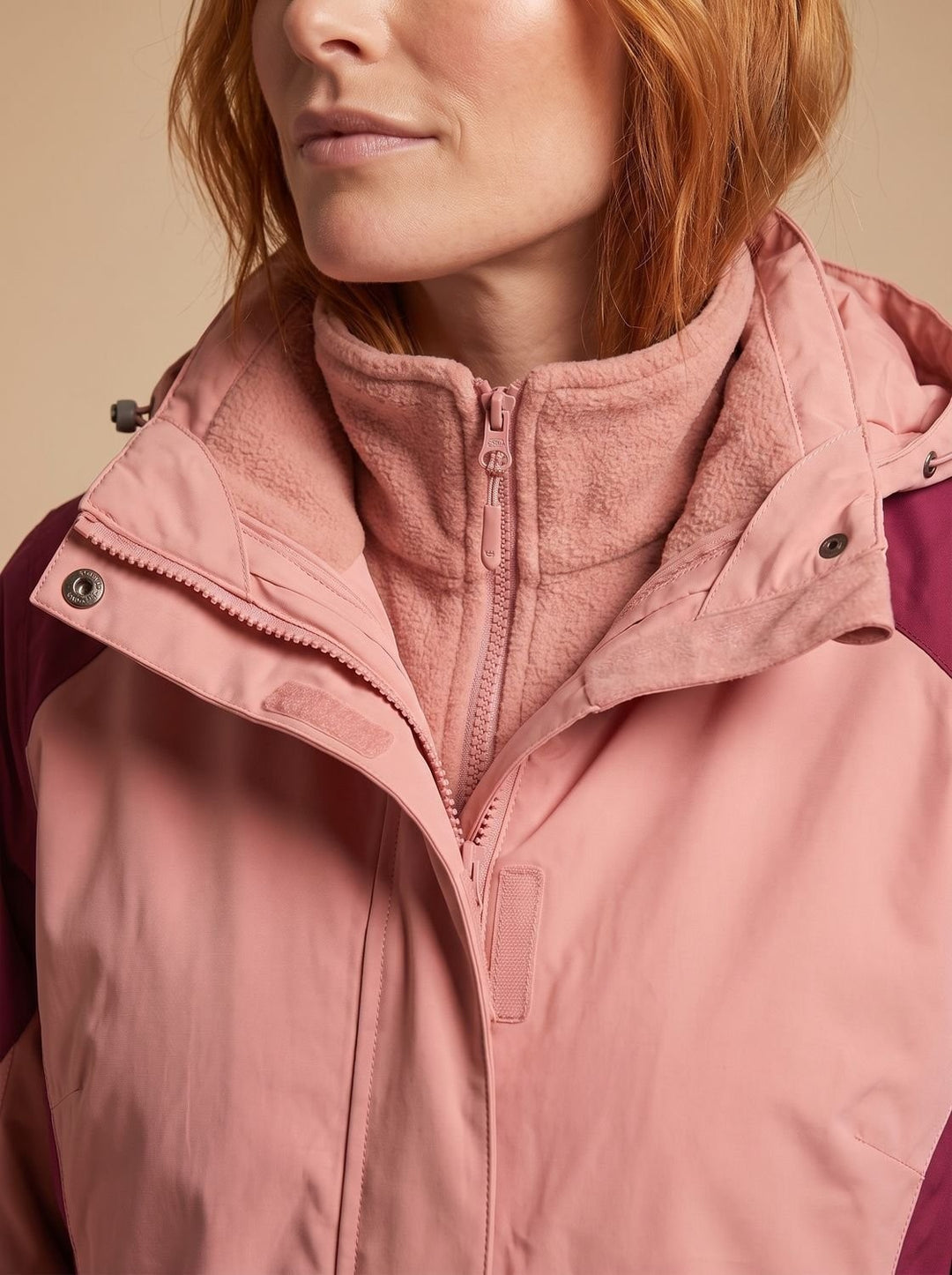 Close-up of pink hooded jacket collar showing zipped fleece inner layer