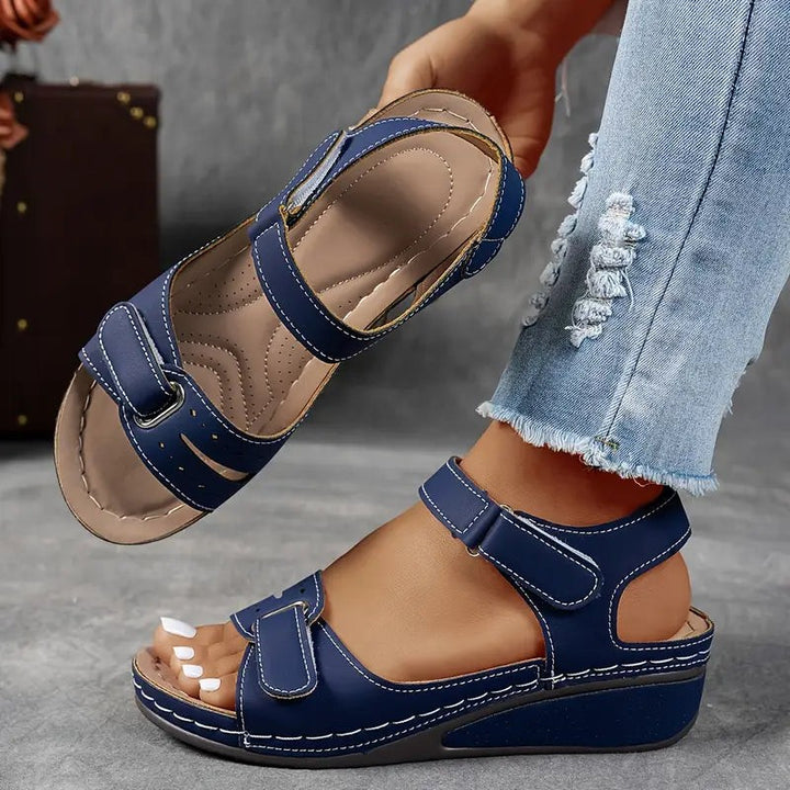 Navy blue orthopedic wedge sandals with cushioned ankle strap design