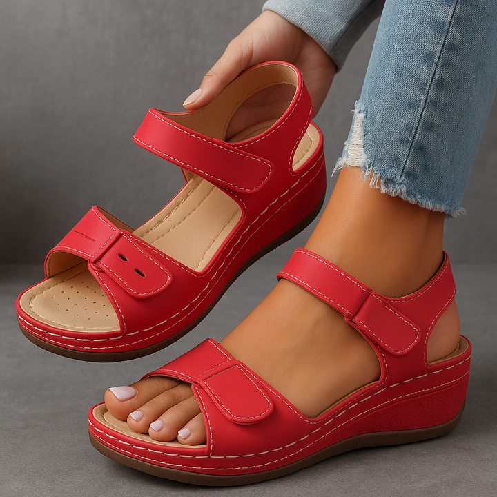 Red wedge sandals with hook-and-loop straps and cushioned insole