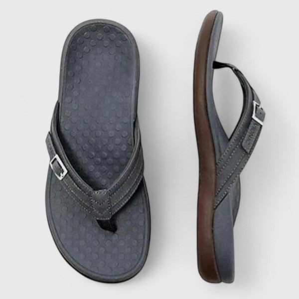 Dark gray leather flip-flop sandals with buckle strap and cushioned sole