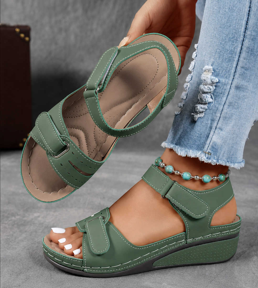 Sage green wedge sandals with adjustable straps and stitched footbed detail
