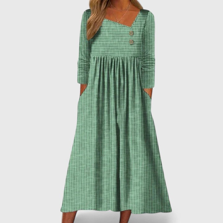 Green striped midi dress featuring long sleeves and empire waist silhouette