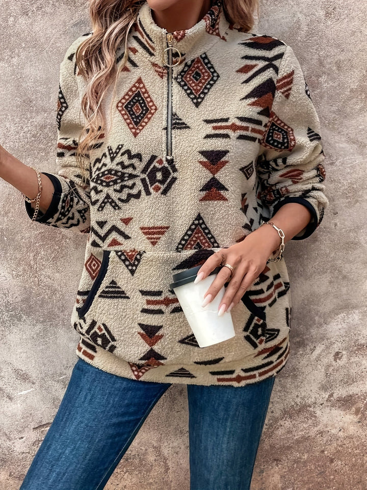 Aztec-print fleece jumper with zip collar, model holding a takeaway coffee cup