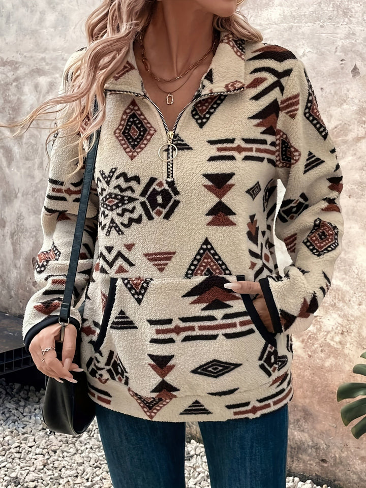 Geometric Aztec-print pullover with front pocket, paired with a black crossbody bag