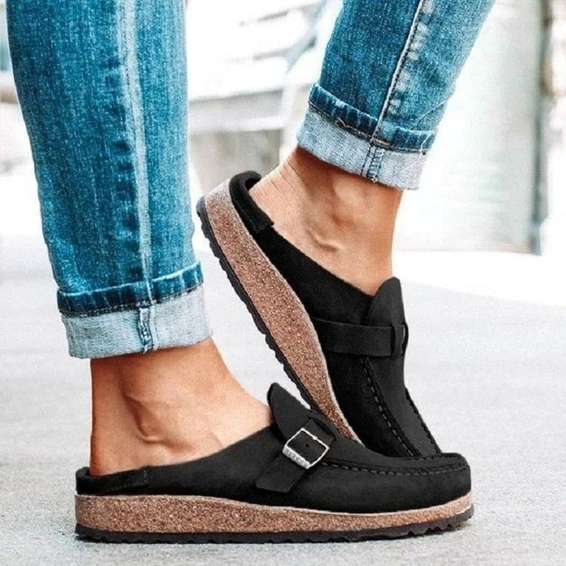 black suede backless loafer with buckle strap and cork sole