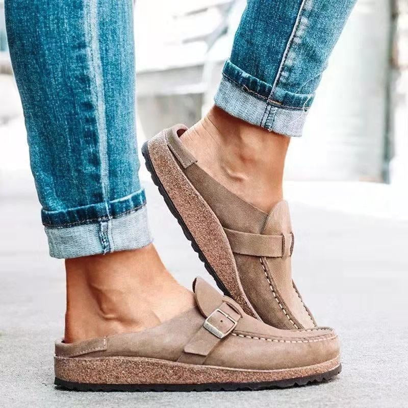 Taupe suede backless clogs featuring buckle detail and cork platform sole