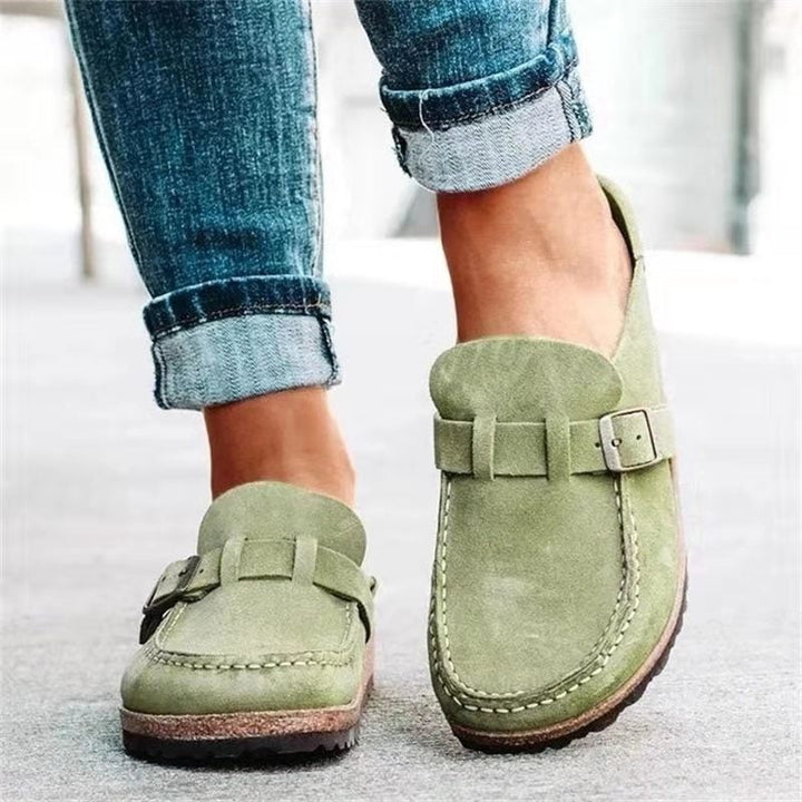 Sage green suede clogs with buckle accent and comfort cork footbed