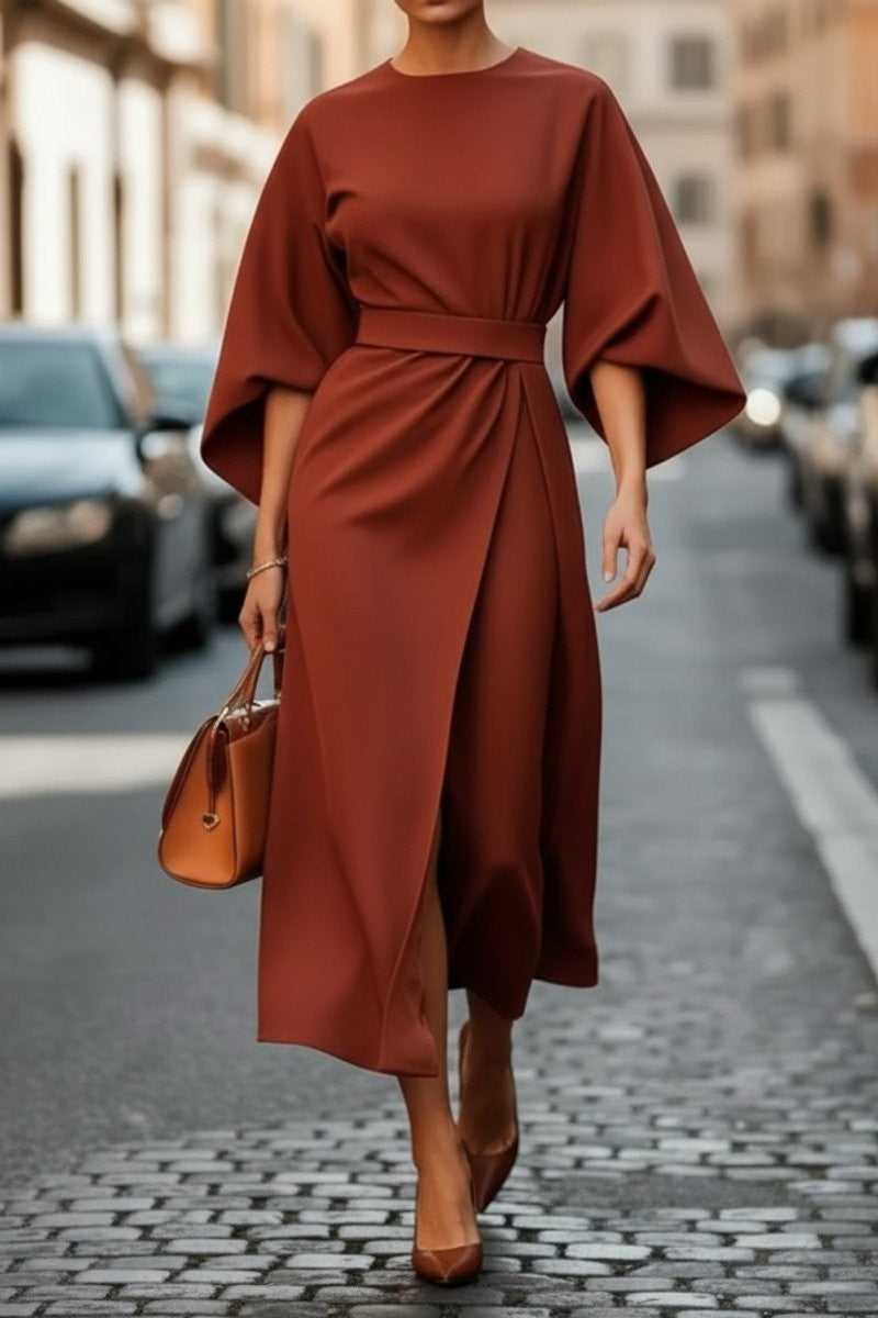 Rust-colored midi dress with lantern sleeves and cinched waist belt