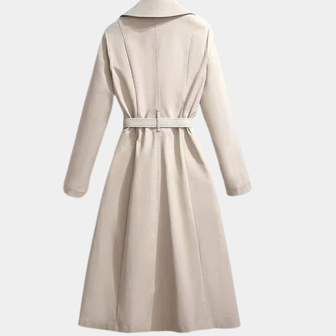 Beige belted trench coat, rear view showing tailored waist and flared midi hem