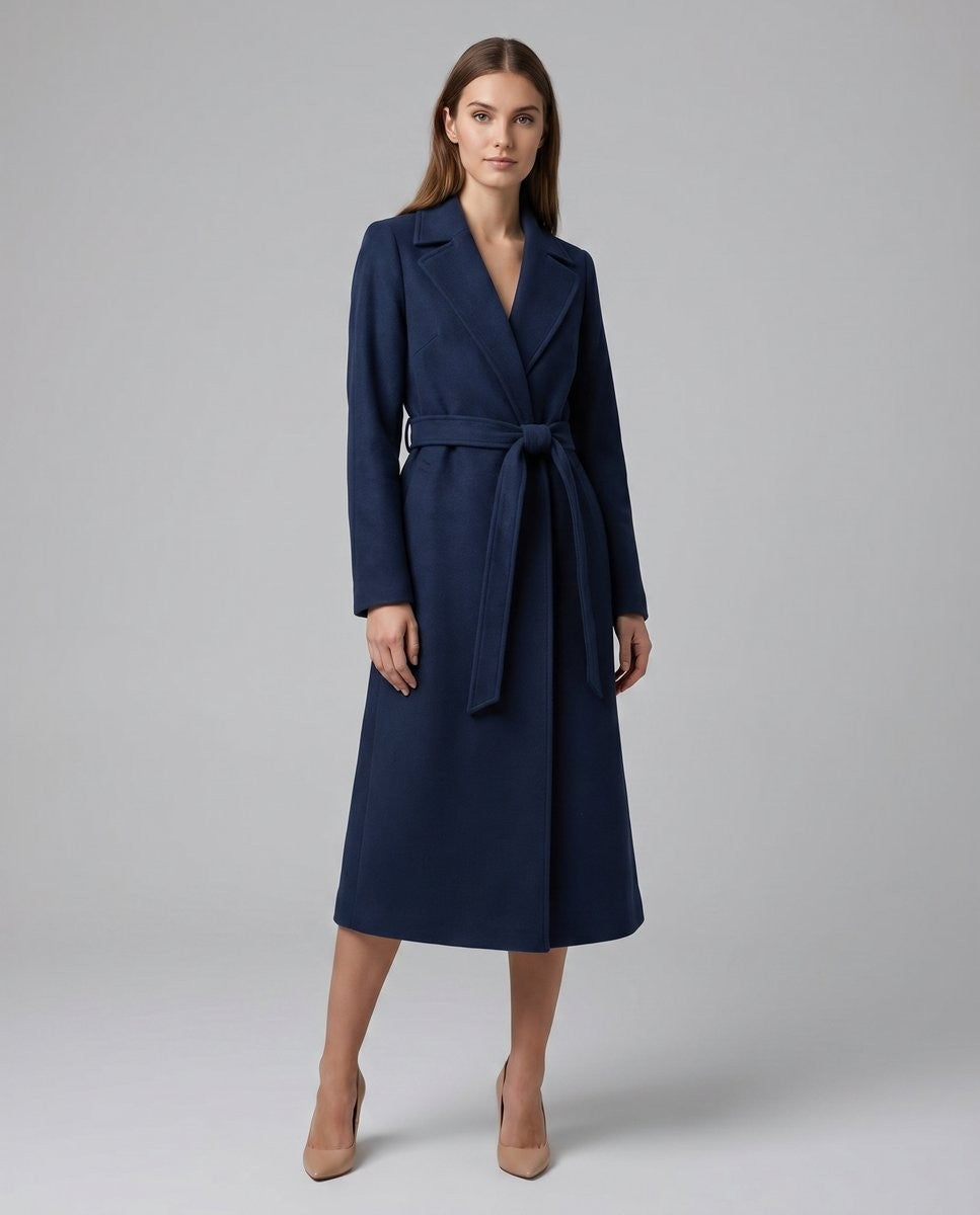 Belted navy long coat with notch lapel worn over black dress