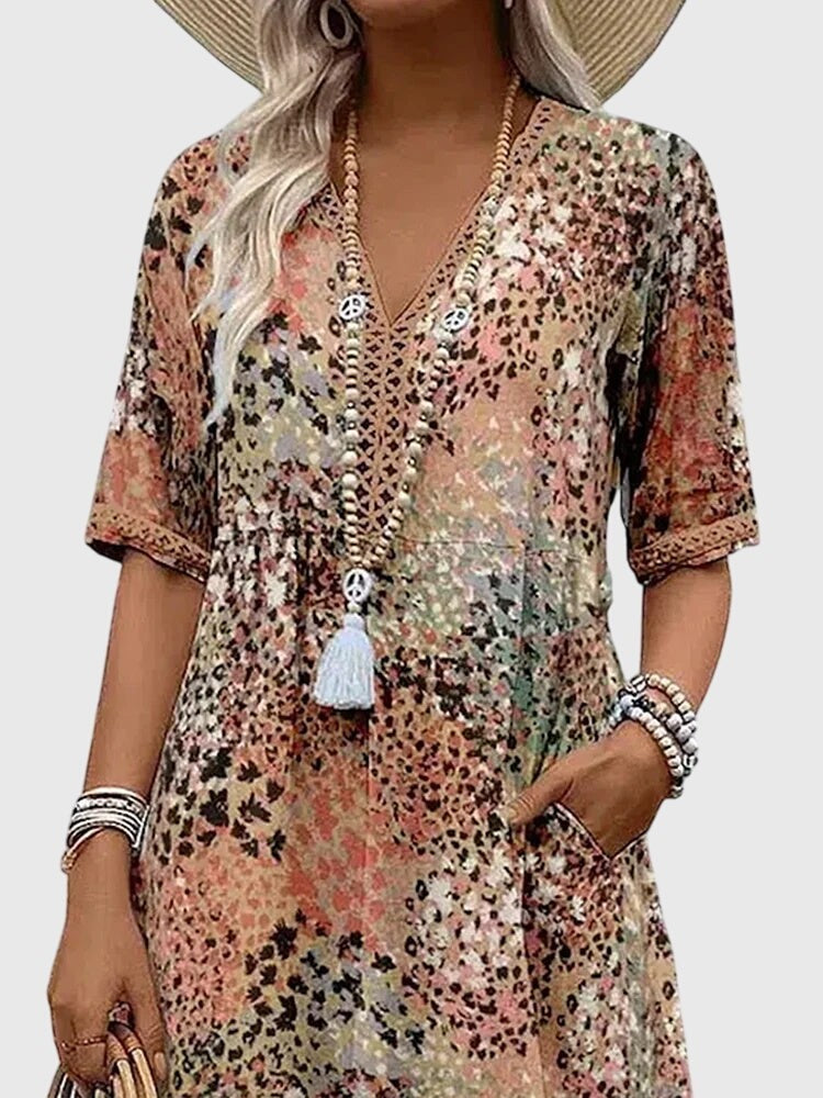 Close-up of earthy floral midi dress with beaded necklace