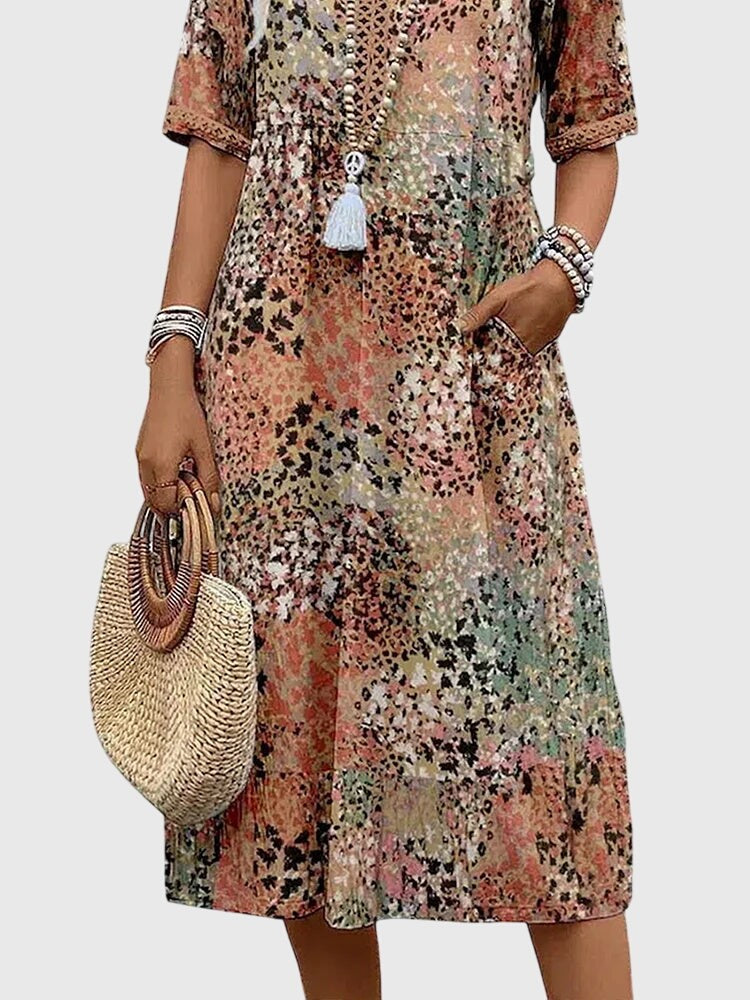 Floral patchwork midi dress detail showing pocket and trim