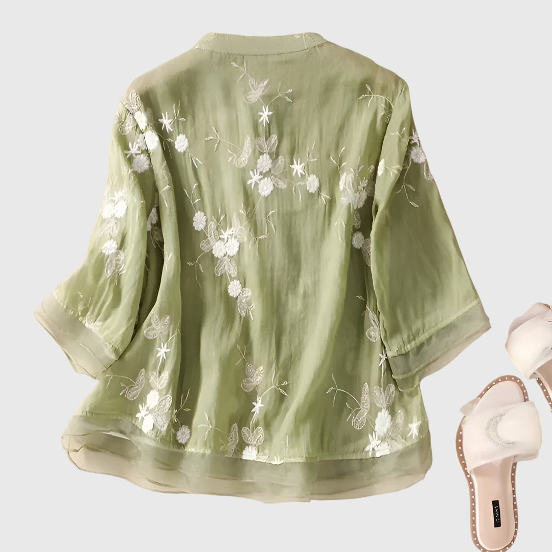 sage green embroidered blouse back view showing floral butterfly detail
