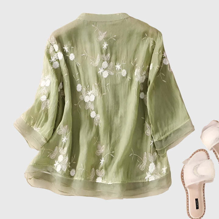 sage green embroidered blouse back view showing floral butterfly detail