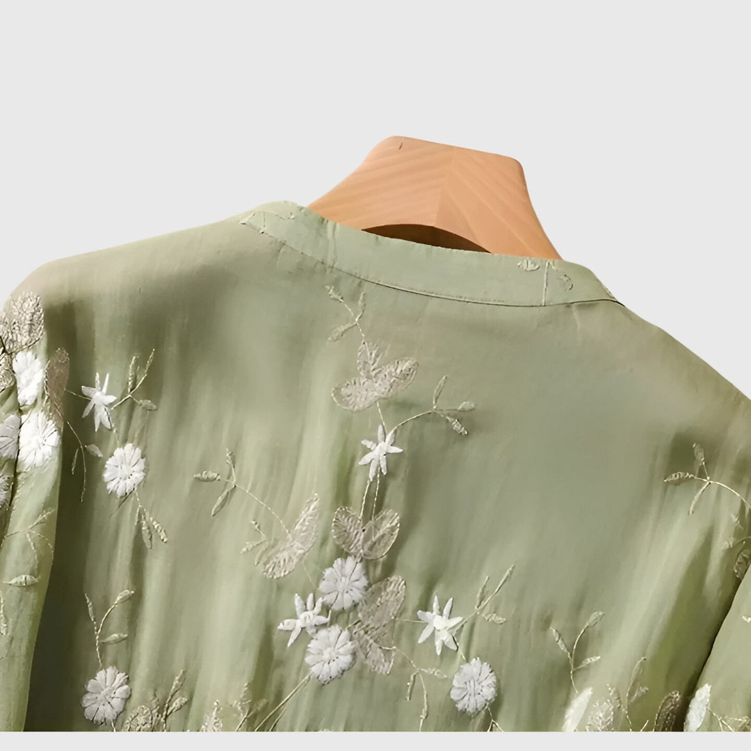 close-up of sage green blouse collar with embroidered floral pattern