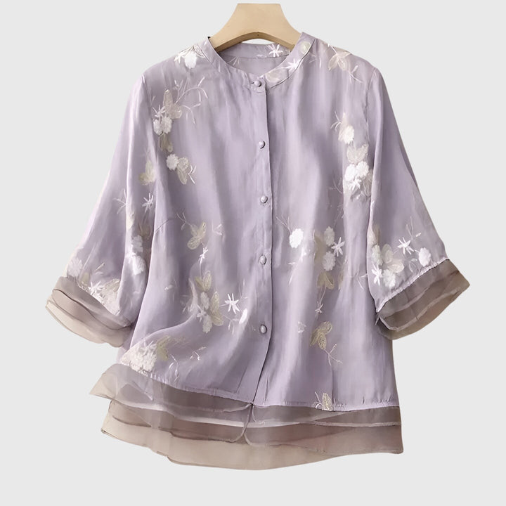 lavender floral embroidered blouse with sheer layered hem on hanger