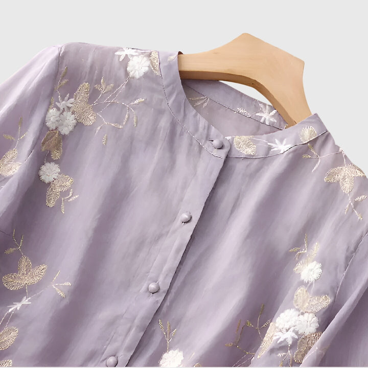 close-up of lavender blouse buttons and gold floral embroidery detail