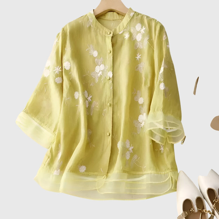 pastel yellow sheer blouse with white floral embroidery and ruffled sleeves