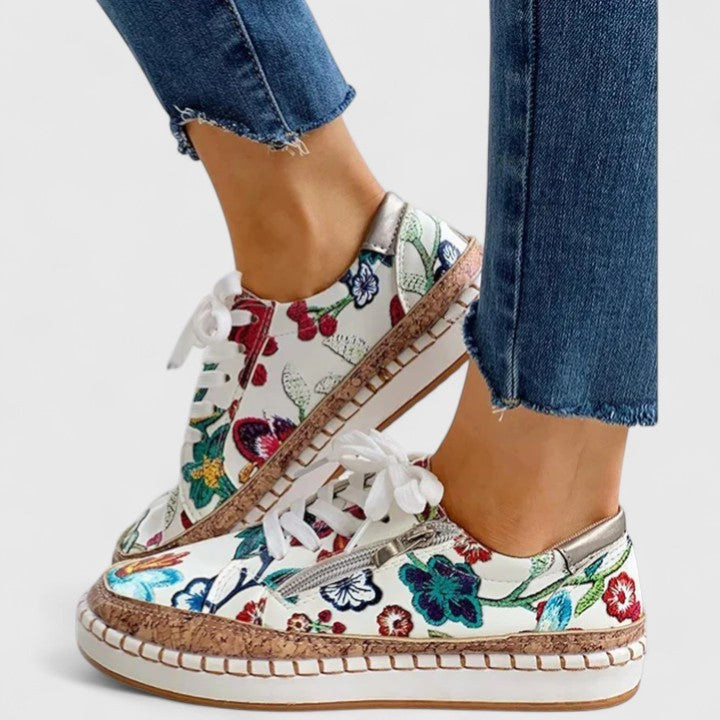 floral print lace-up sneakers with cork sole worn with denim jeans