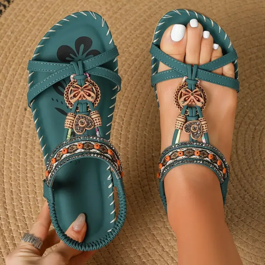 Teal boho flat sandals with beaded straps and butterfly charm detail