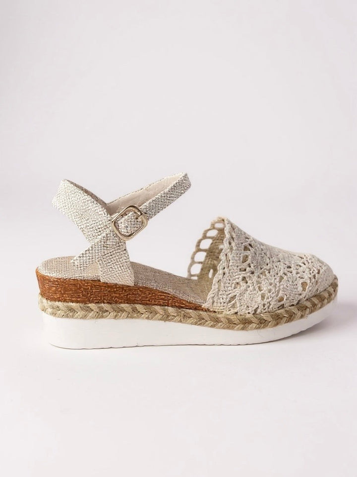 Side profile of cream woven espadrille sandal with braided jute wedge