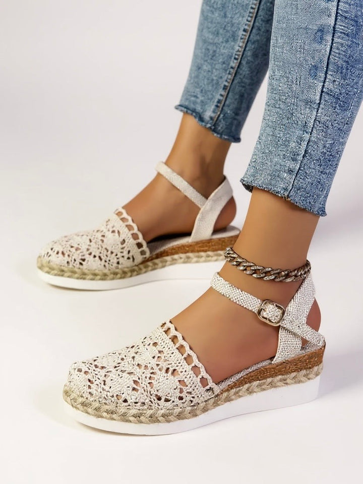 Cream crochet wedge sandals worn with cropped denim and ankle strap