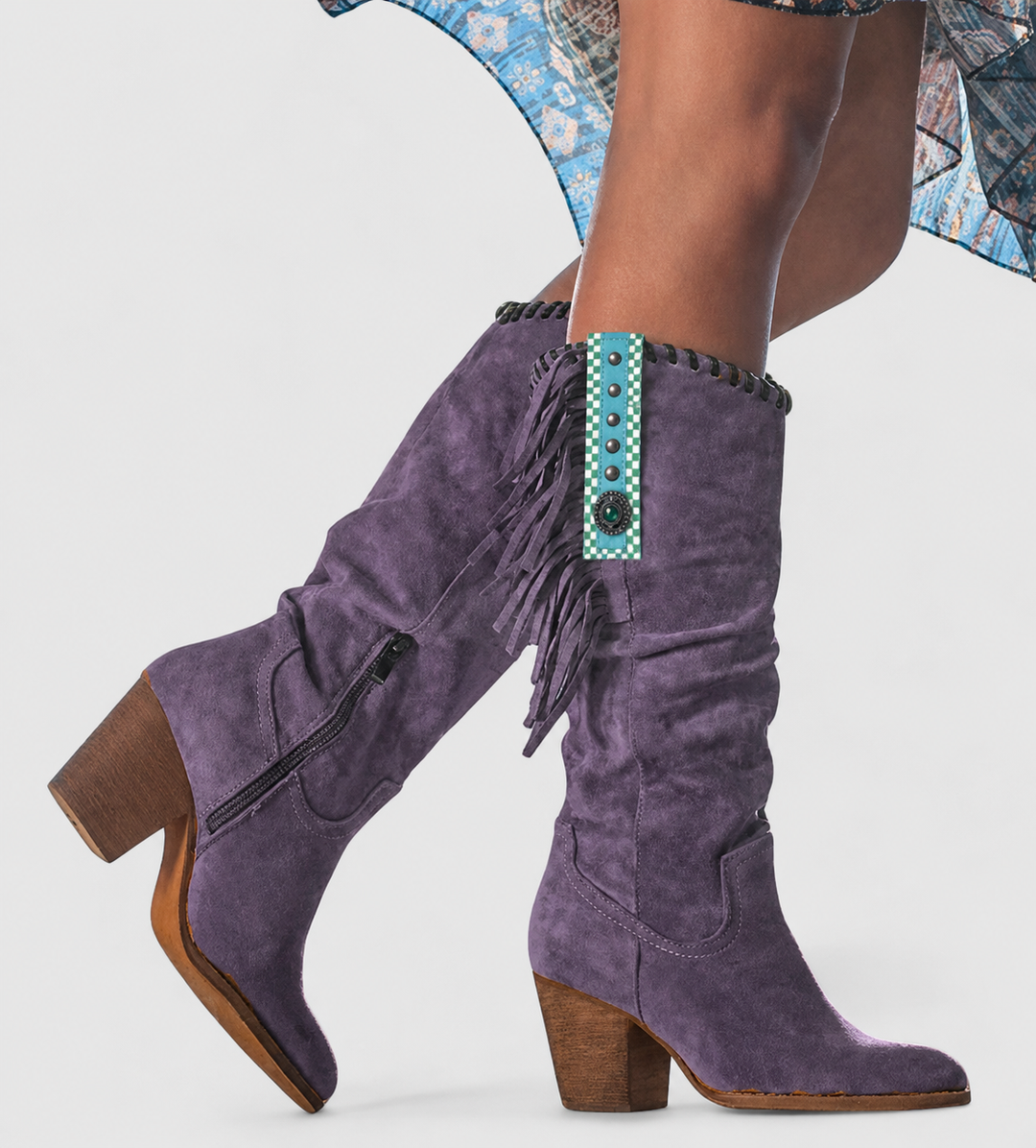 Purple suede knee-high boots featuring fringe trim and stacked block heel