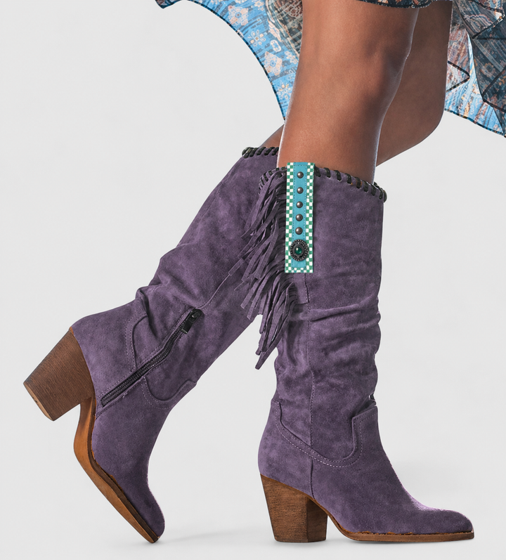 Purple suede knee-high boots featuring fringe trim and stacked block heel