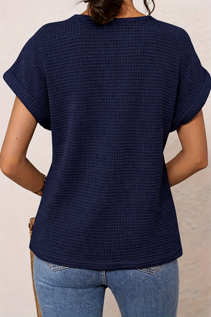 Back view of navy blue waffle-knit top with dolman sleeves