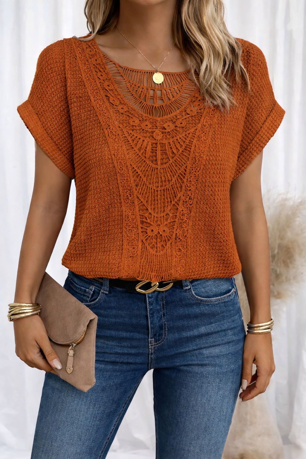 Rust orange knit top featuring crochet lace neckline detail
