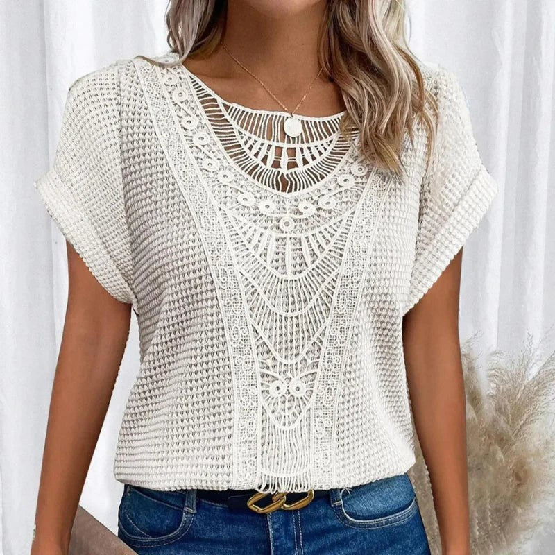 Ivory waffle-knit top featuring crochet lace panel and fringe hem