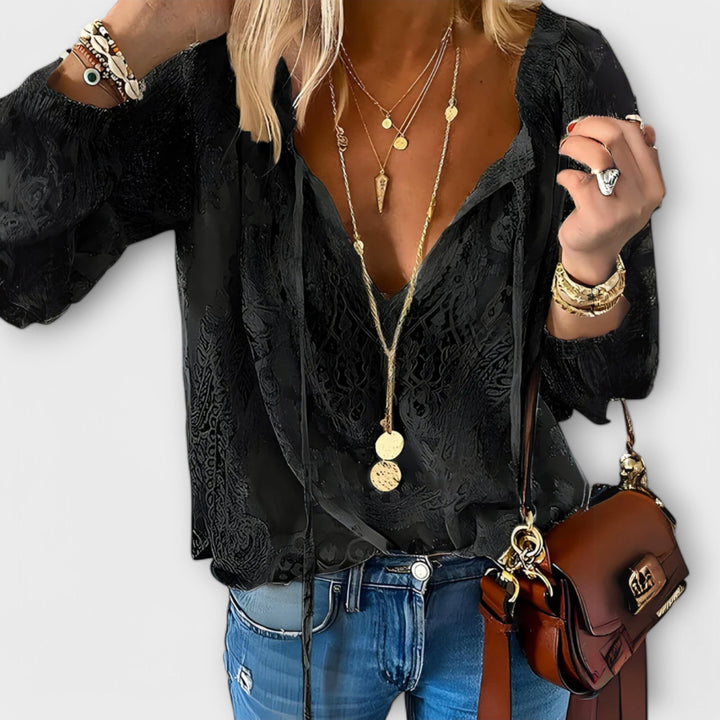 Black textured lace blouse featuring deep V-neck and tie front detail