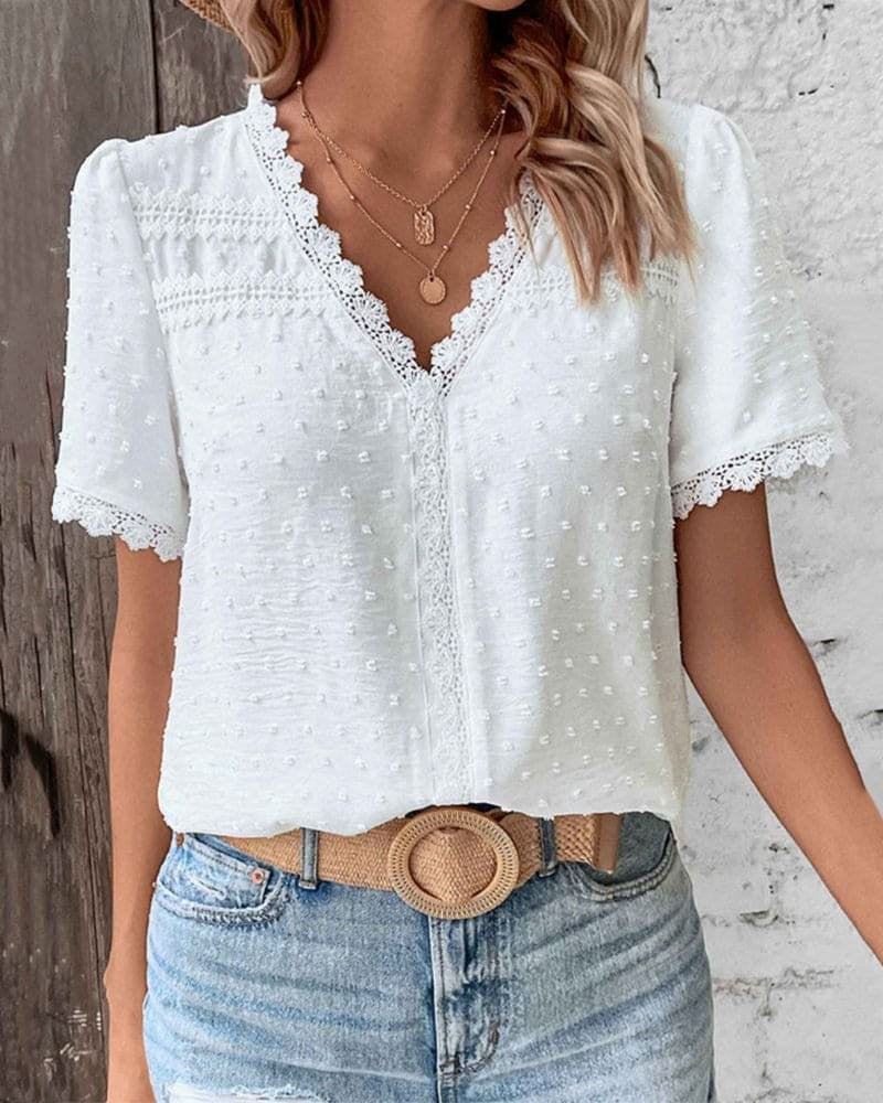 White boho blouse featuring scalloped lace trim and dotted texture