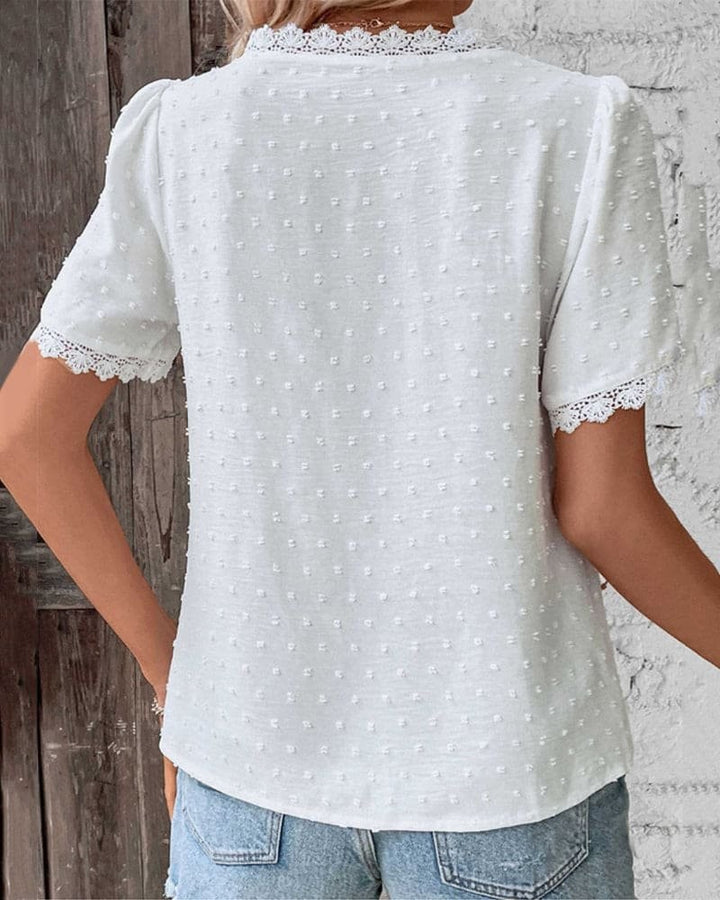 Back view of white Swiss dot blouse showing lace-trimmed sleeves