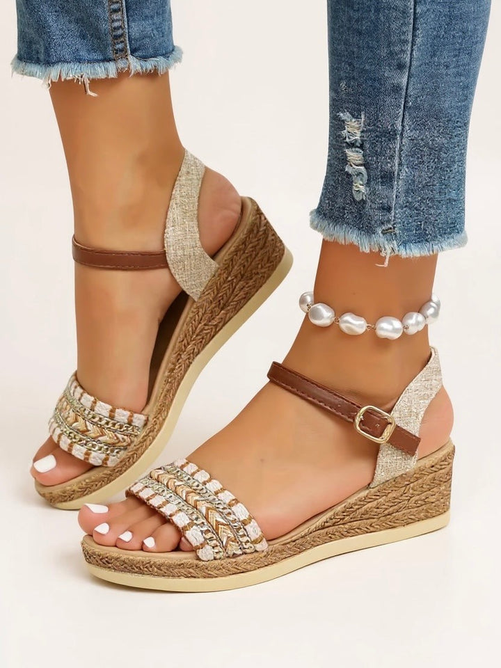 ankle strap espadrille wedge sandals paired with cropped raw-hem jeans