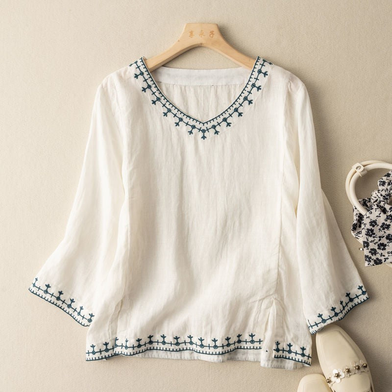 White linen blouse with embroidered V-neck and bell sleeves