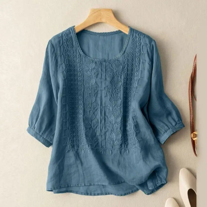 Blue floral embroidered blouse with three-quarter sleeves and asymmetrical hem