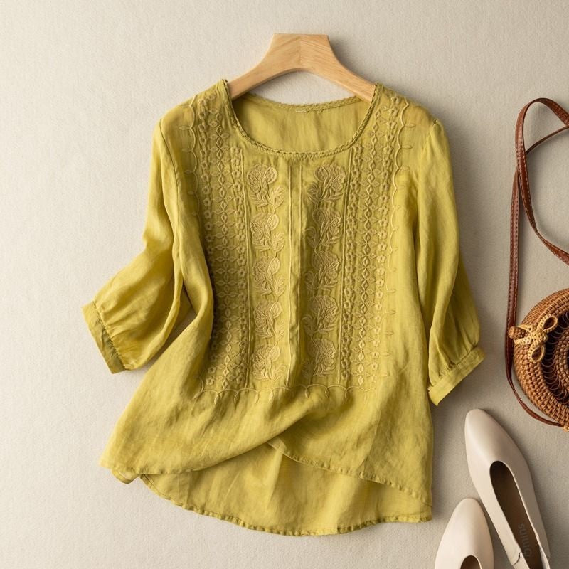 Yellow floral embroidered blouse with three-quarter sleeves and curved hemline