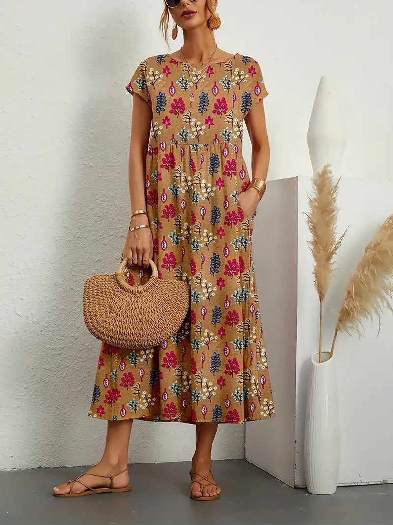 Tan botanical print midi dress paired with sandals and a straw handbag