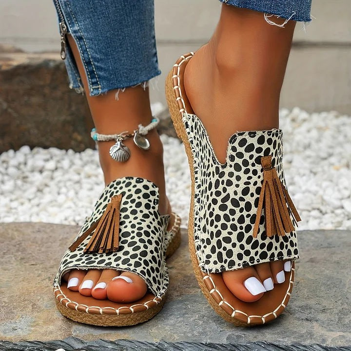 Cheetah print flat slide sandals with brown suede tassel trim