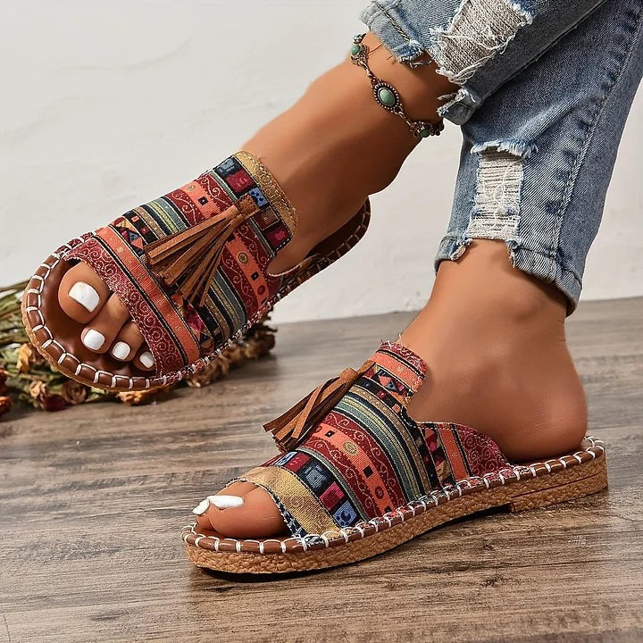 Cheetah print flat sandals with suede tassel and stitched leather trim