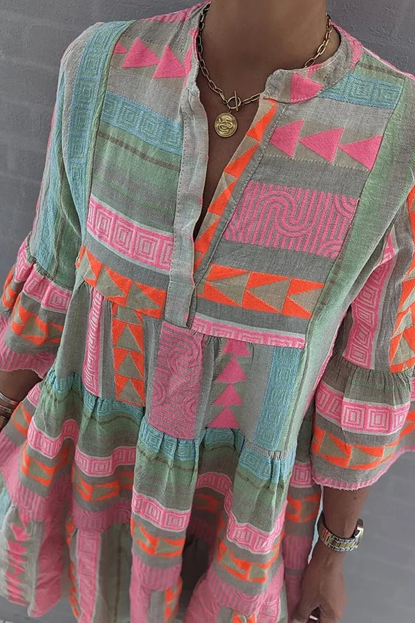 Close-up of tunic dress bodice showing tribal geometric print fabric texture