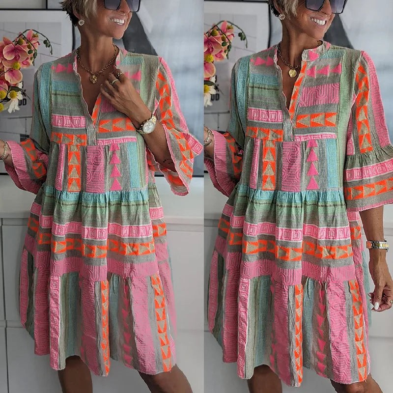 Side-by-side views of pink and orange tiered geometric print midi dress
