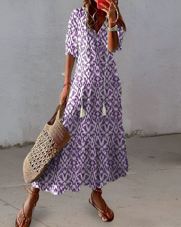 purple and white ikat print maxi dress with tasseled neckline