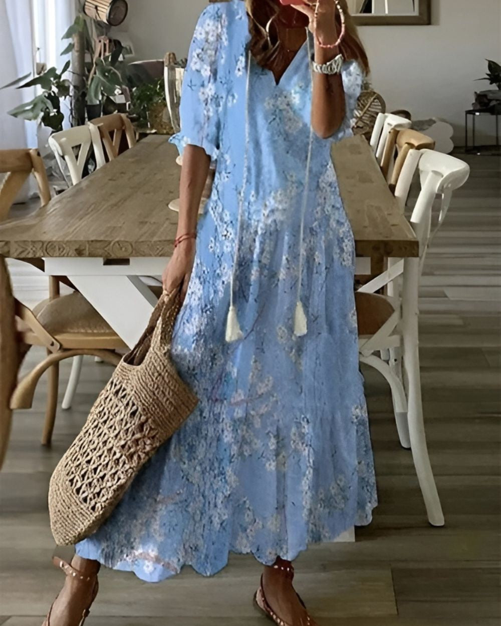 Pale blue floral print maxi dress with V-neckline and tasselled drawstring